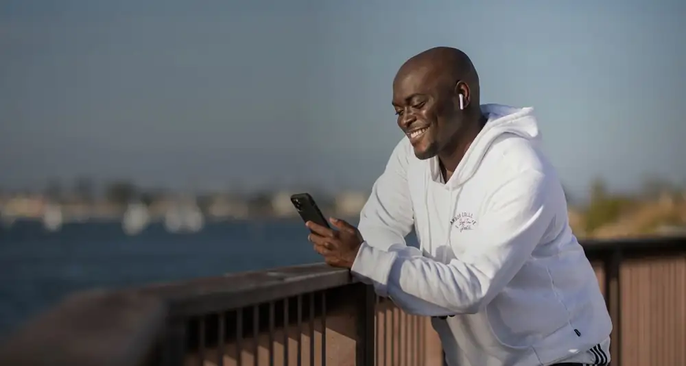 Smiling customer checking his phone
